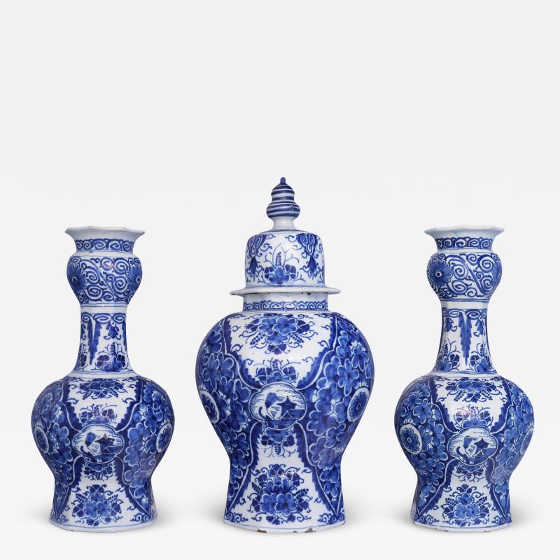 An early 18th century Dutch Delft Blue and White Garniture of Three Vases