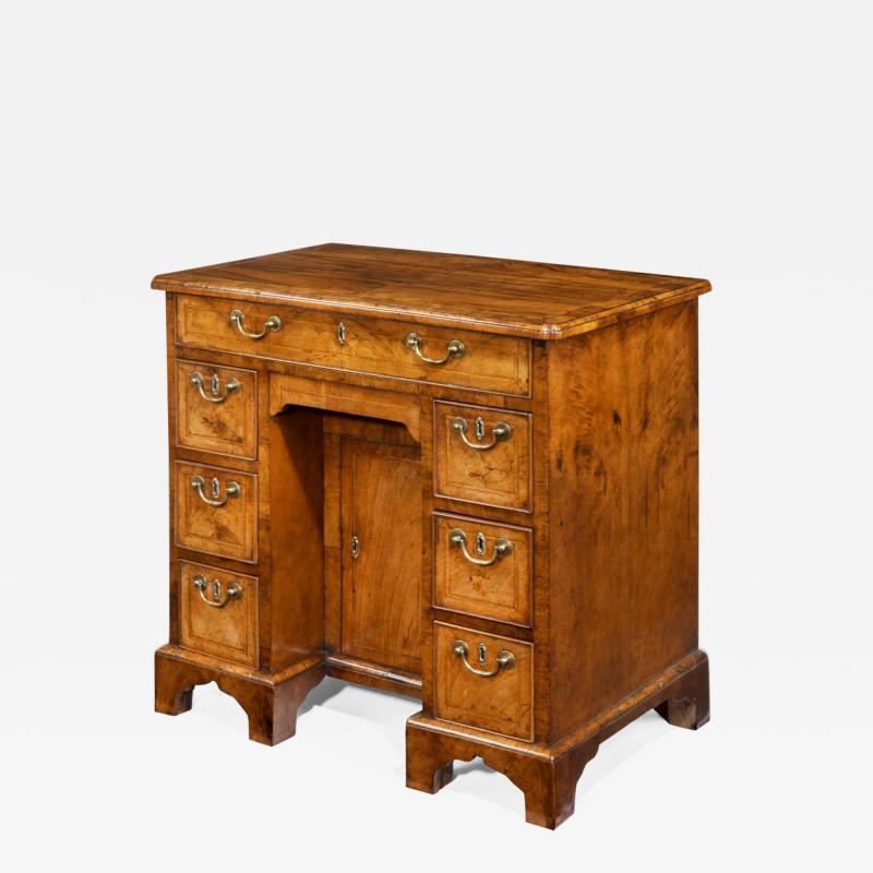 An early George III walnut kneehole desk