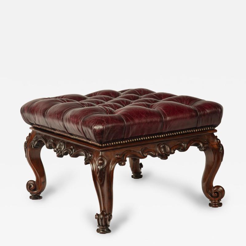 An early Victorian leather upholstered rosewood stool