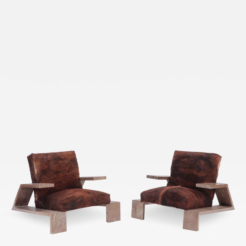An imposing pair of cerused oak armchairs with cow skin upholstery Contemporary