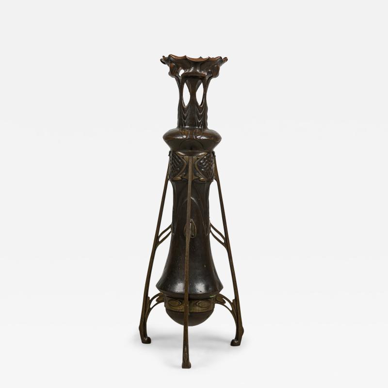 Art Nouveau bronze floor vase supported by 3 open design legs