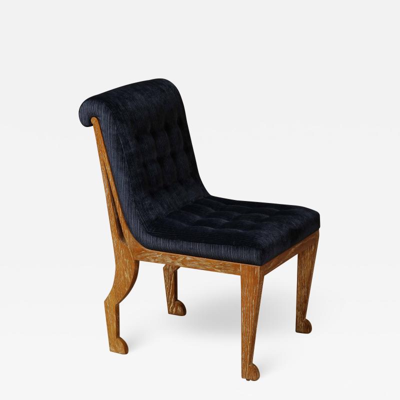Blue velvet tufted chair in the style of Marc du Plantier