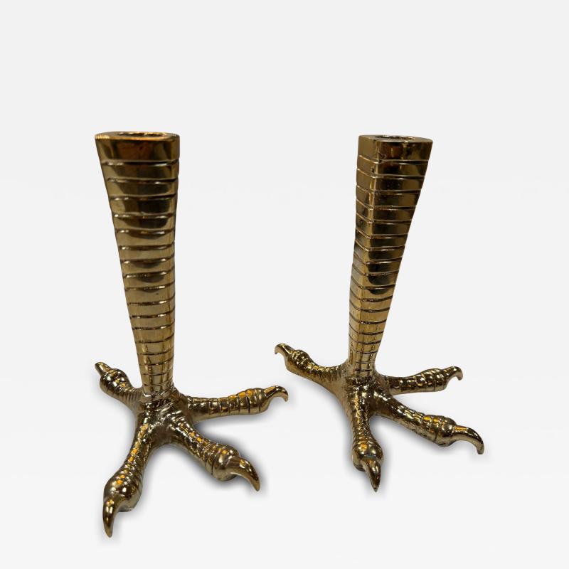 Brass candle holders designed in the shape of bird talons
