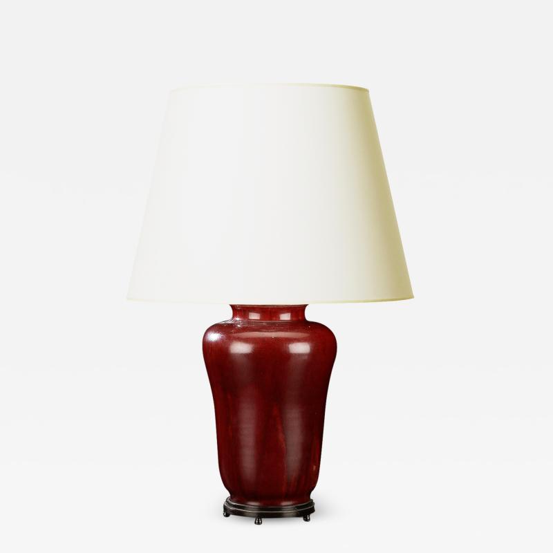 Carl Halier Exquisite table lamp with oxblood glaze and bronze stand by Carl Halier