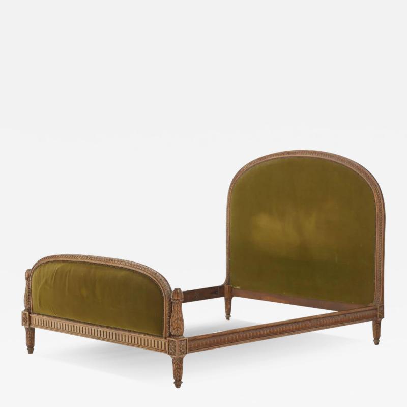 Carved walnut French bed having a shaped head and footboard C 1920 