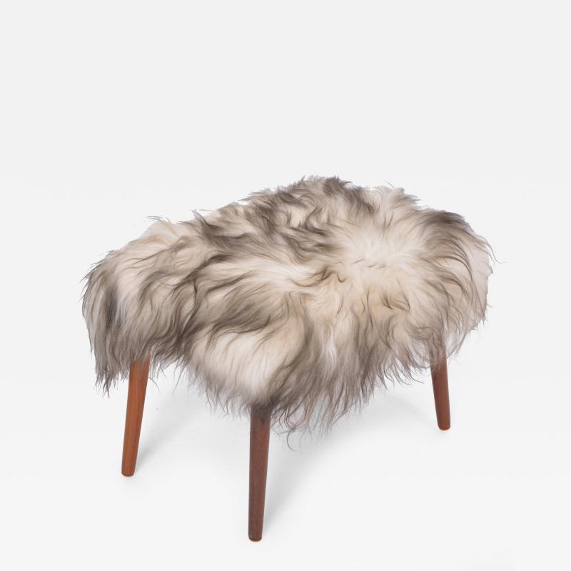 Danish Mid century Modern stool reupholstered in white and black sheep skin