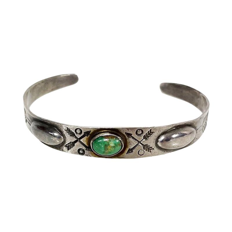 Dine Navajo bracelet with repousse center turquoise stone and stamped designs