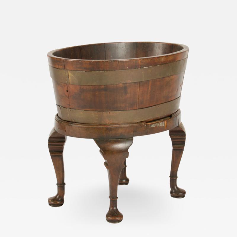 English oval oak planter or wine cooler with brass braces and tin liner on stand