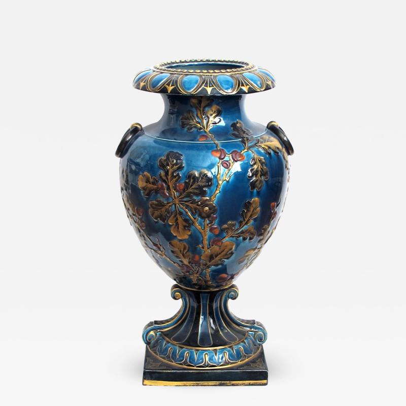 Exquisitely rendered English teal glazed ceramic urn with raised decoration