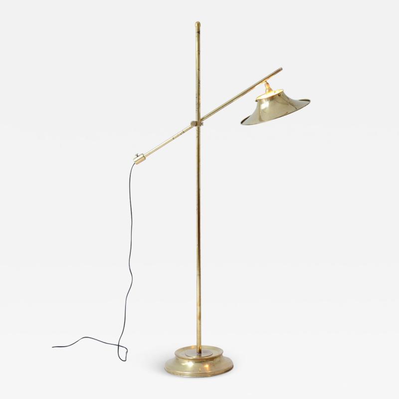 Floor lamp in brass with rocker rod base and cap in shaped and perforated brass