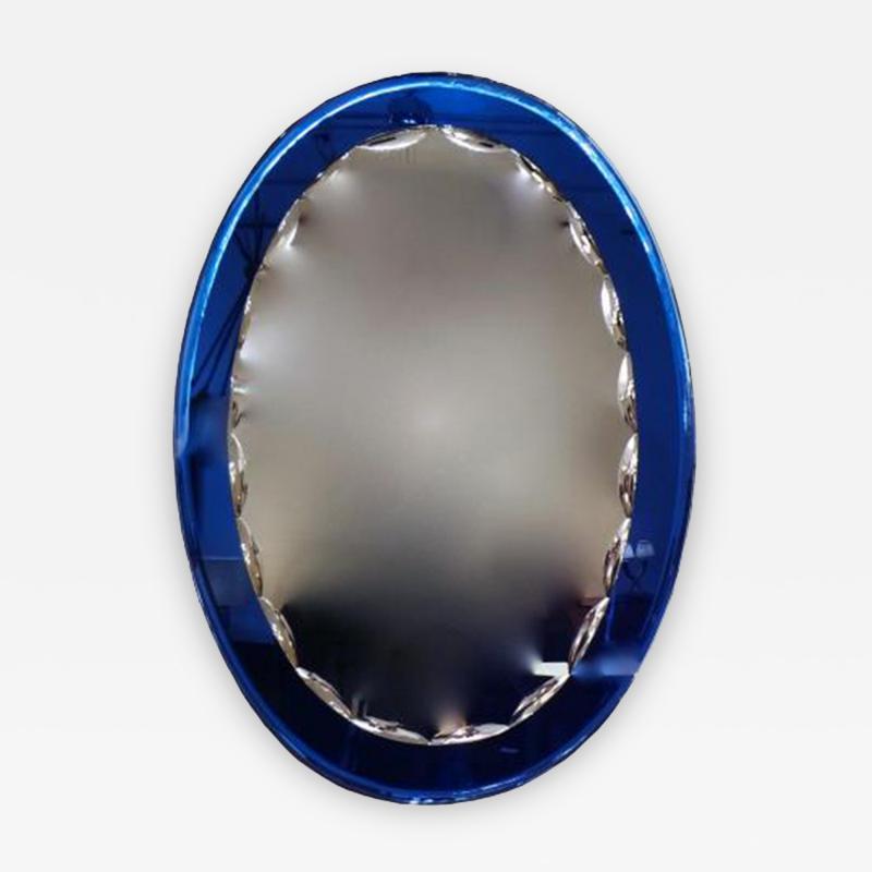 Fontana Arte An Oval Wall Mirror with a Blue Mirrored Frame in the style of Fontana Arte