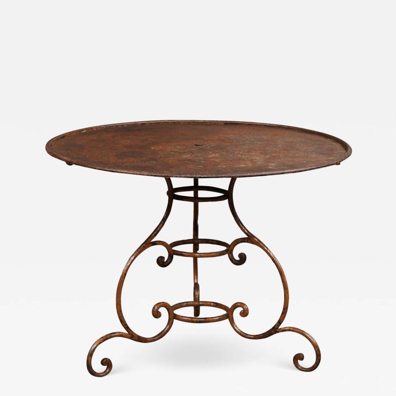 French 19th Century Round Iron Garden Table with Scrolling Base and Rusty Finish