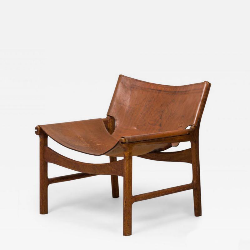 Illum Wikkels Danish Mid Century Caramel Leather and Oak Sling Design Lounge Ch