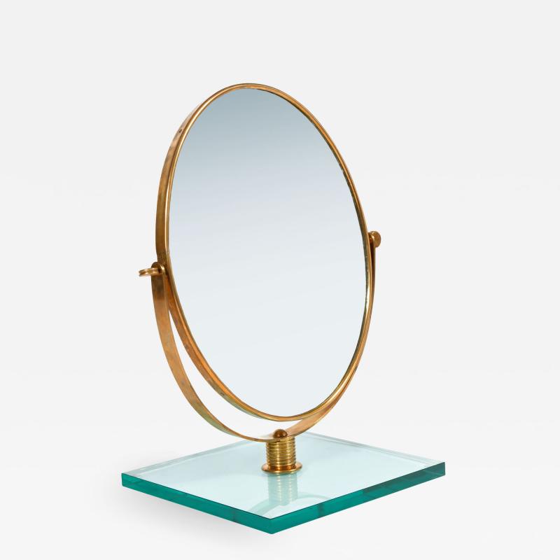 Italian 1950s brass table mirror on glass stand in the style of Gio Ponti