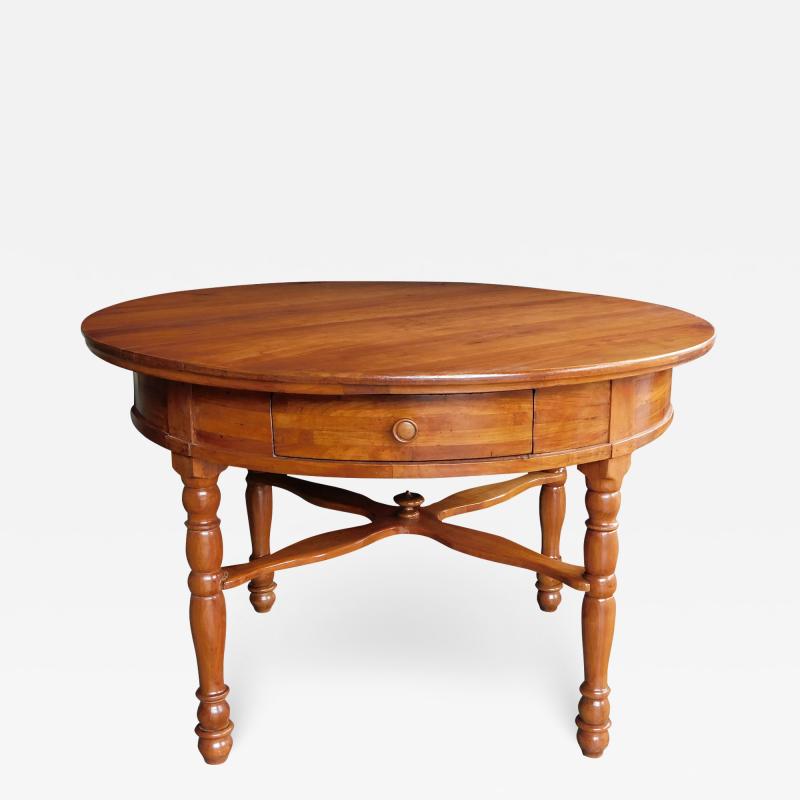 Large Swiss cherrywood single drawer circular center table