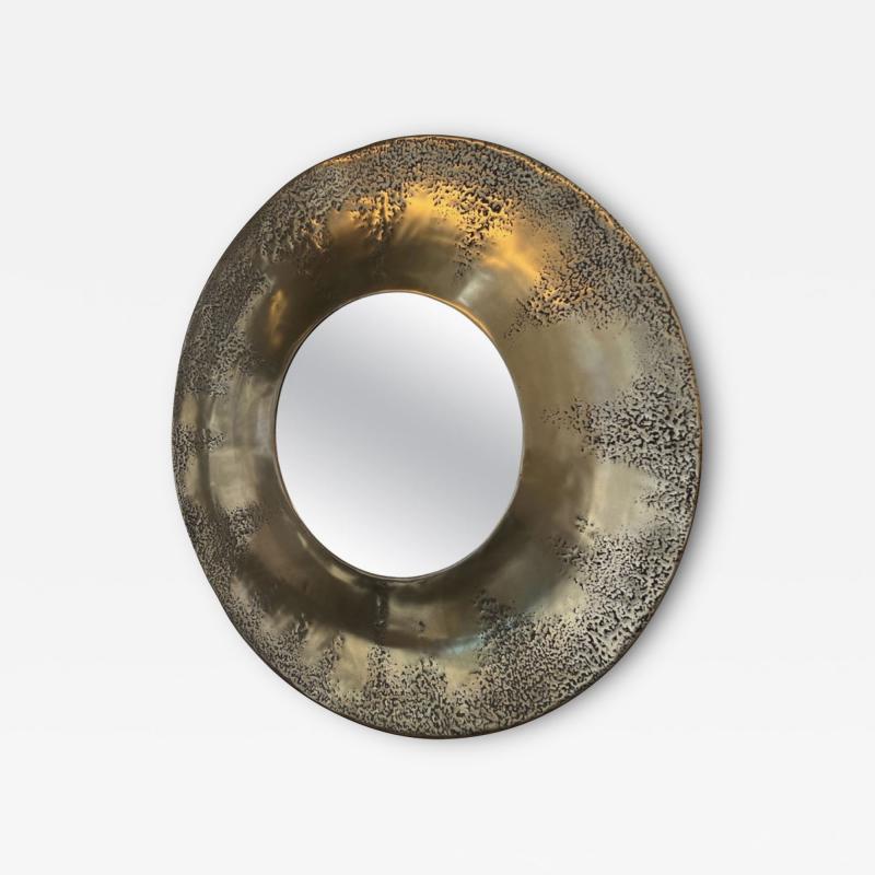 Large circular mirror with concave and textured brass surround