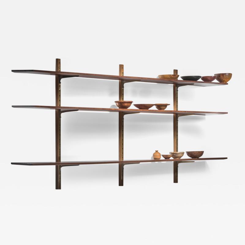 Large shelving unit with brass brackets