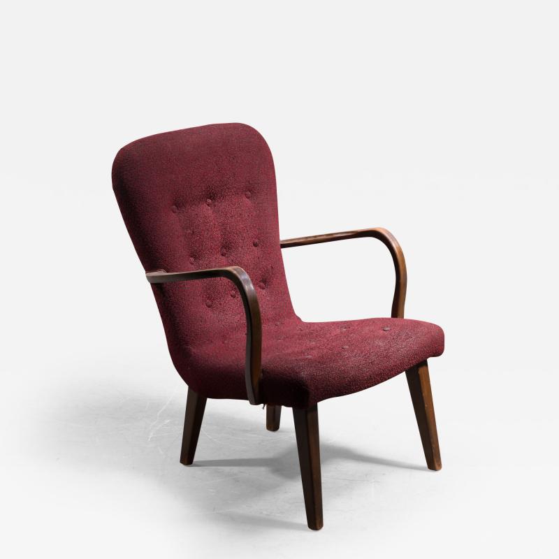 Lounge chair with curved armrests and red upholstery Denmark 1940s