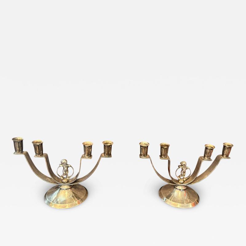MODERNIST PAIR OF ART DECO SILVERED CANDELABRA WITH STYLIZED CHERUB IN RING