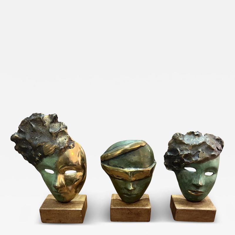 MODERNIST SUITE OF THREE BRUTALIST BRONZE MASK SCULPTURES