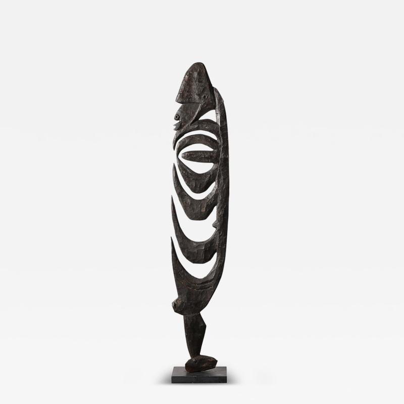 Male Yipwon Figural Carved Wood Sculpture on Stone Base