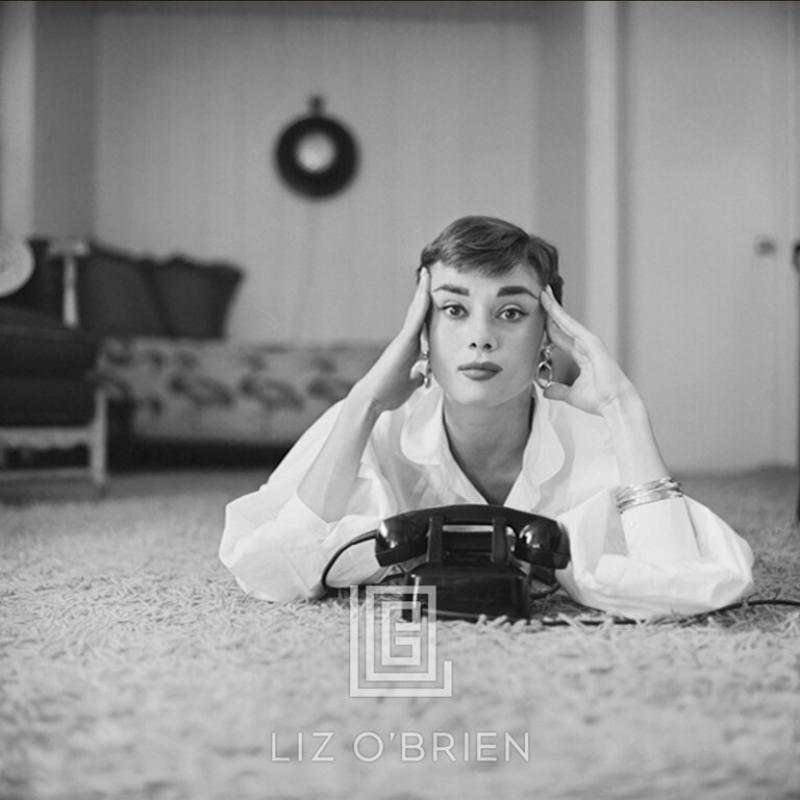 Mark Shaw Audrey Hepburn in White Blouse with Phone Laying Fingers on Temples 1953