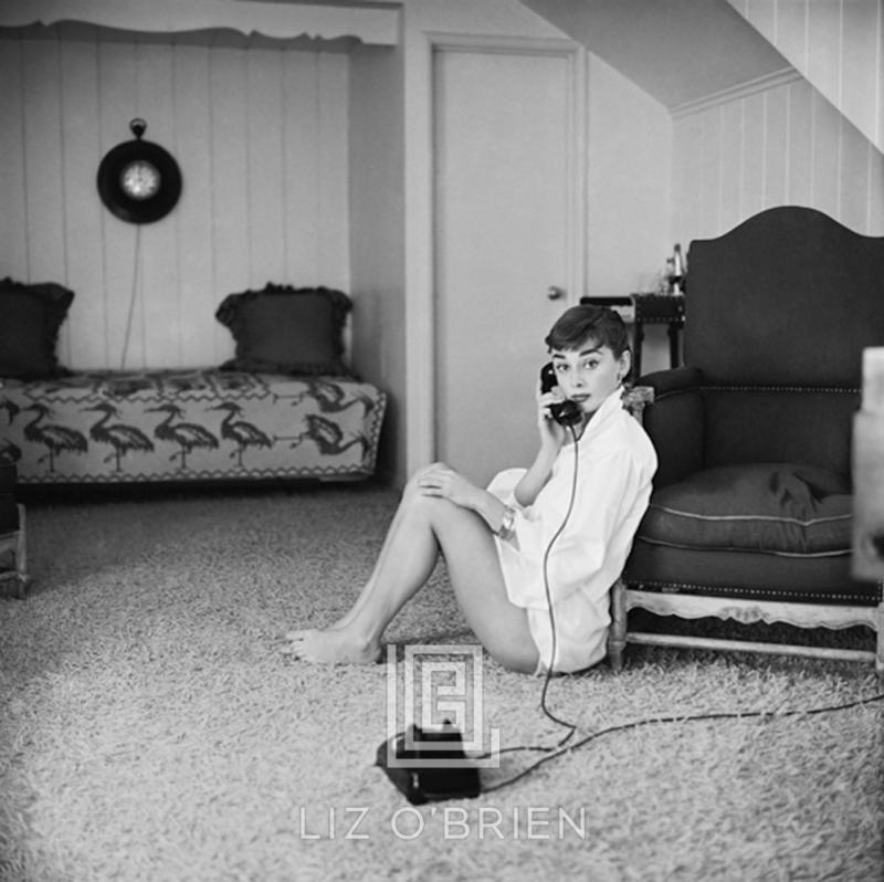 Mark Shaw Audrey Hepburn in White Blouse with Phone Leaning Against Chair 1953