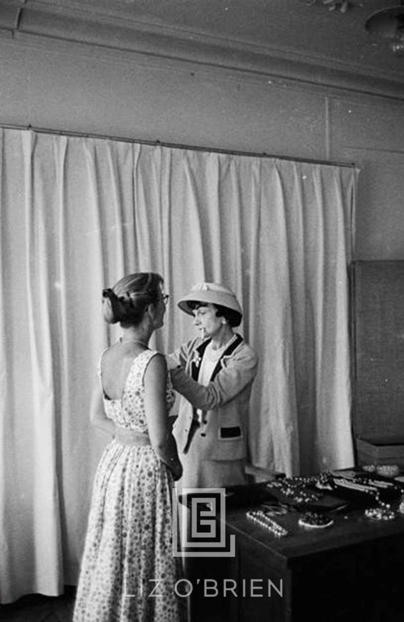 Mark Shaw Coco Chanel Arranges Jewels on her Assistant