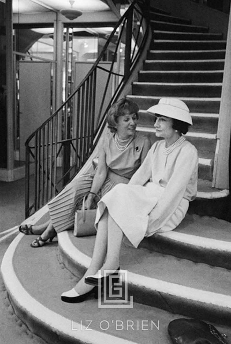 Mark Shaw Coco Chanel Sits on Stairs with Unidentified Woman