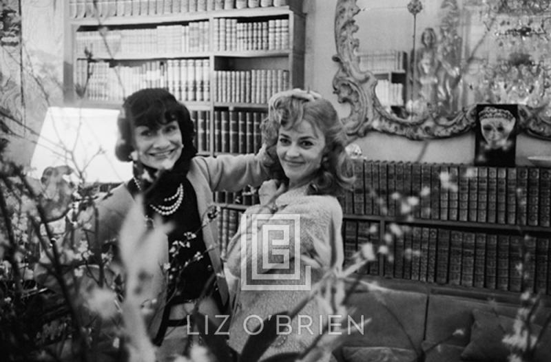 Mark Shaw Coco Chanel and Jeanne Moreau Behind Flowers