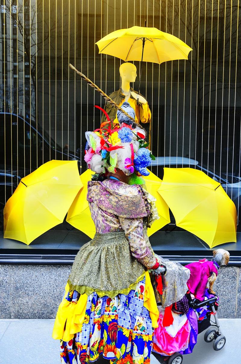 Mitchell Funk Street Photography of Eccentric Women with Colorful Cloths and Yellow Umbrellas