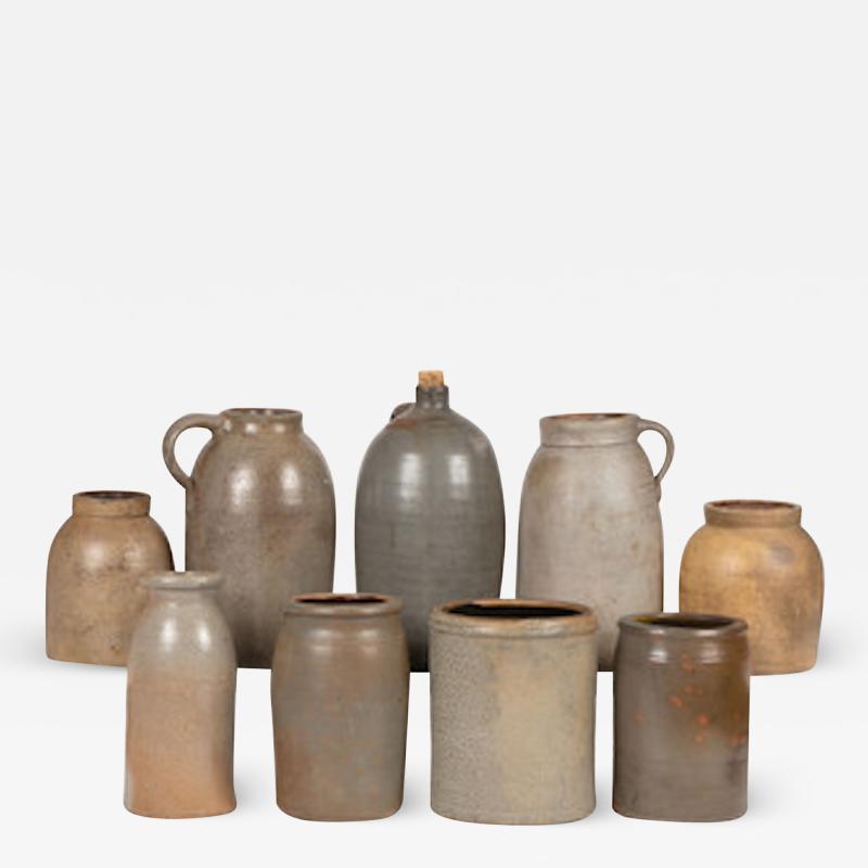 Nine Stoneware Bottles Jugs and Jars