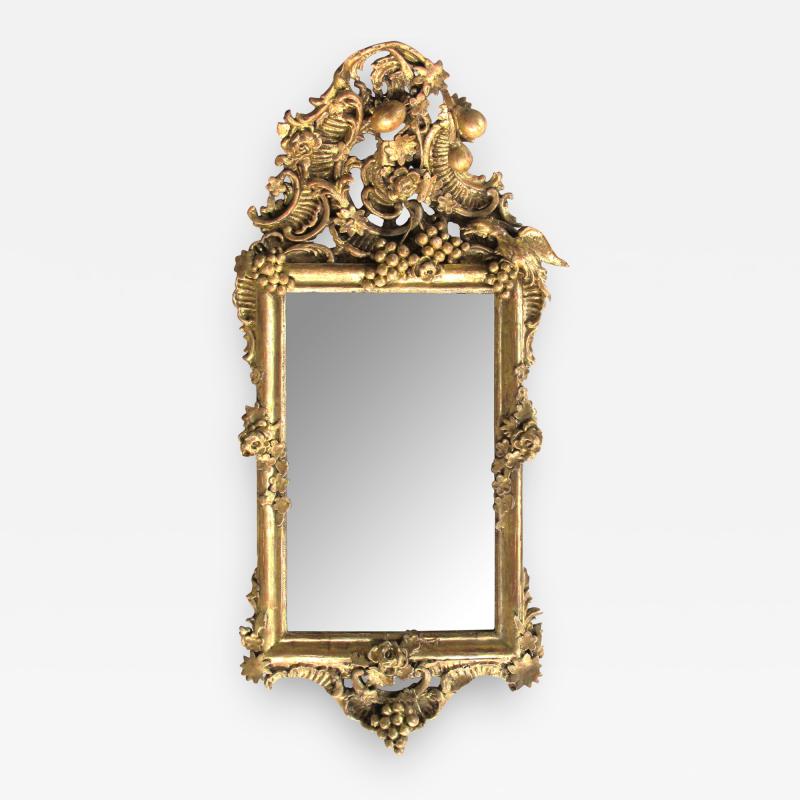 Ornately Carved French Rococo Gilt wood Mirror with Exuberant Crest