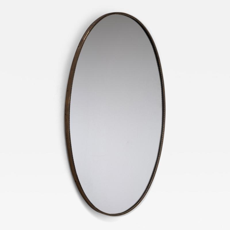 Oval brass mirror with beaded decoration