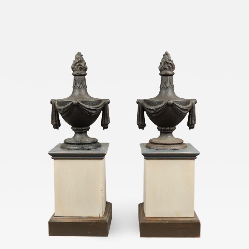 PAIR OF CAST IRON URN FINIALS WITH FLAME TOPS AND SWAGS