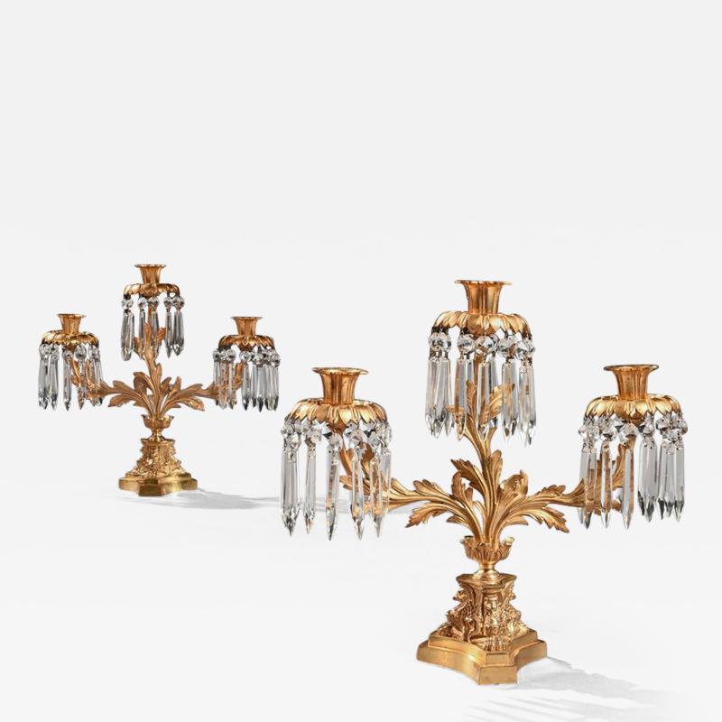 PAIR OF EARLY 19TH CENTURY GILT BRONZE AND LUSTRES THREE BRANCH CANDELABRA