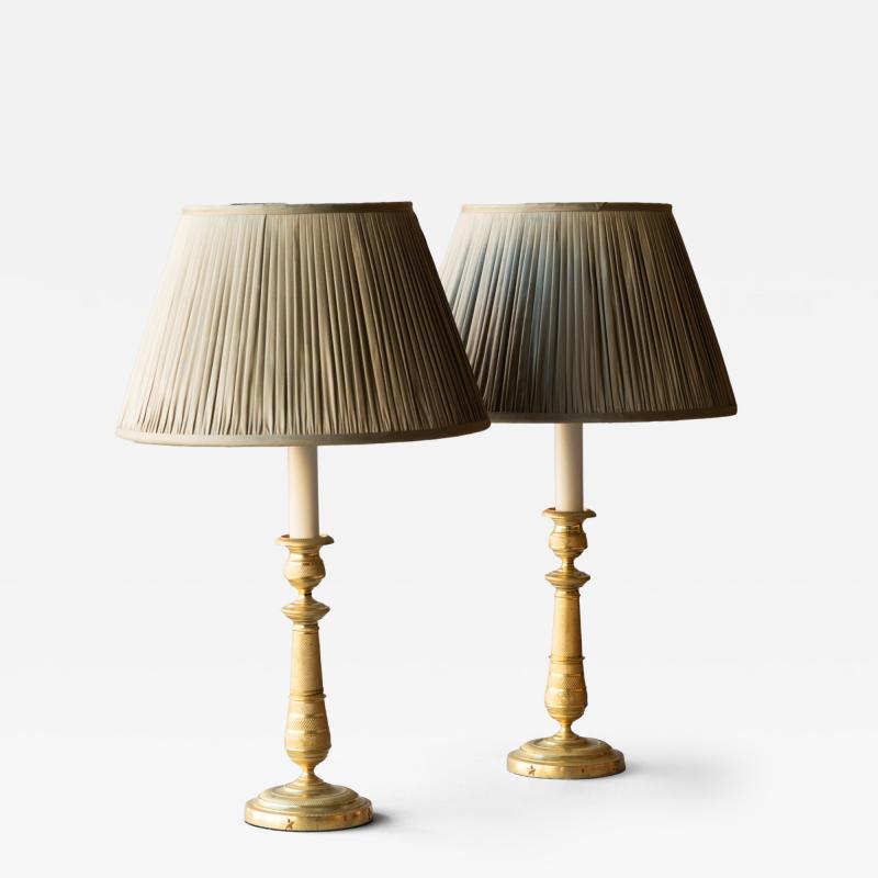 PAIR OF EARLY 19TH CENTURY GILT BRONZE CANDLESTICKS CONVERTED TO TABLE LAMPS