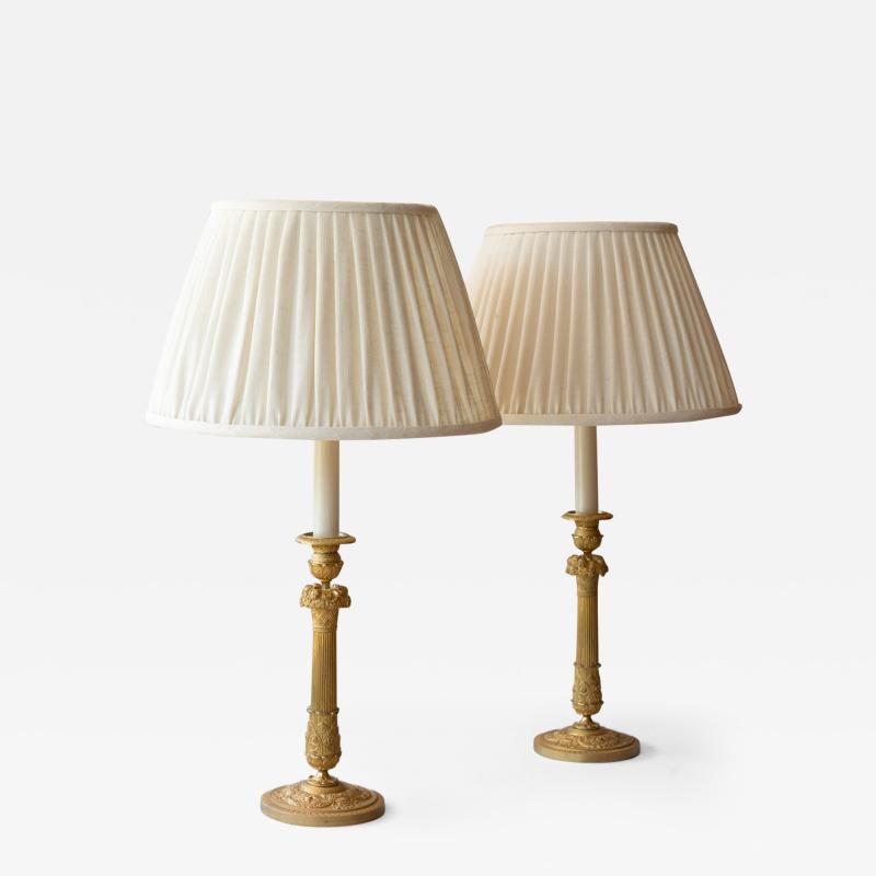 PAIR OF RESTAURATION PERIOD GILT BRONZE CANDLESTICKS CONVERTED TO TABLE LAMPS