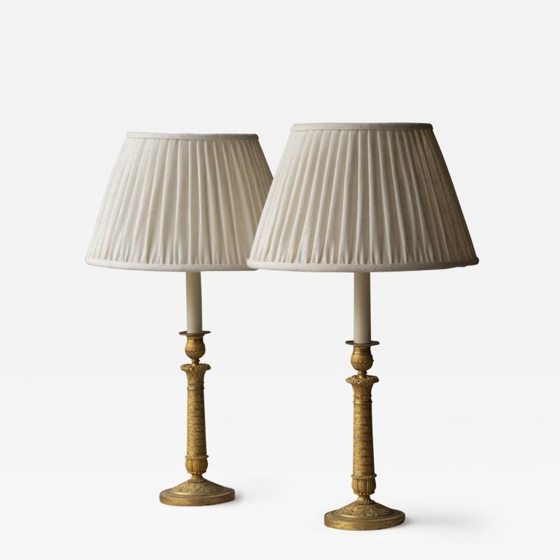 PAIR OF RESTAURATION PERIOD GILT BRONZE CANDLESTICKS CONVERTED TO TABLE LAMPS