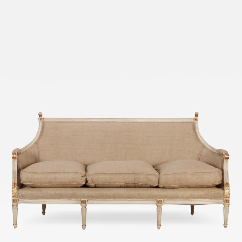 Painted Louis XVI style six leg sofa circa 1940 with gilt hightlights