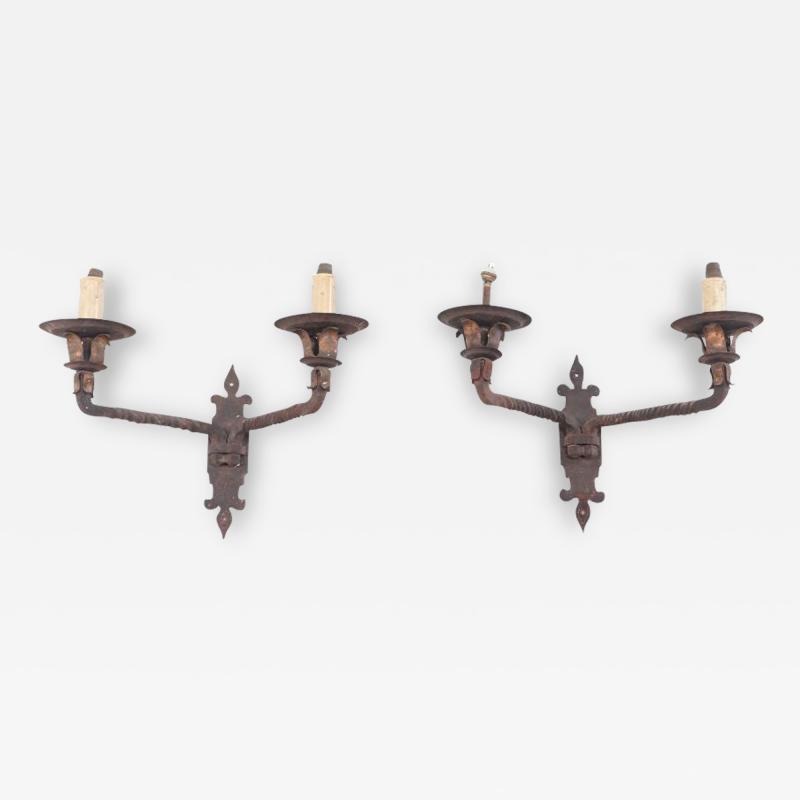 Pair French iron two arm wall sconces with old traces of gold circa 1910 