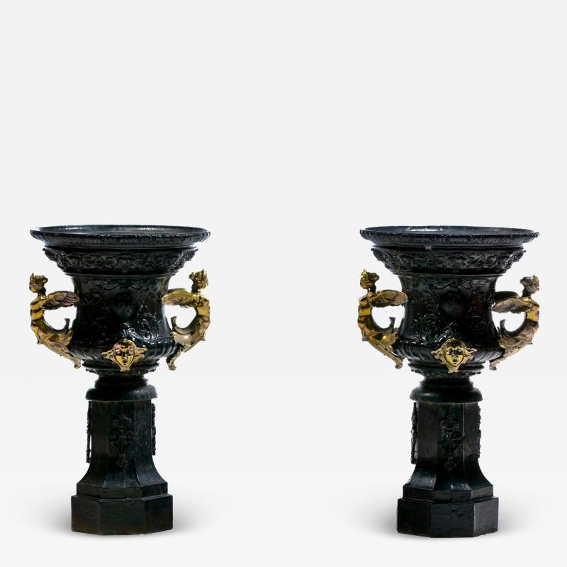 Pair of Antique French Rococo Style Black Iron Urns Adorned with Brass Figures