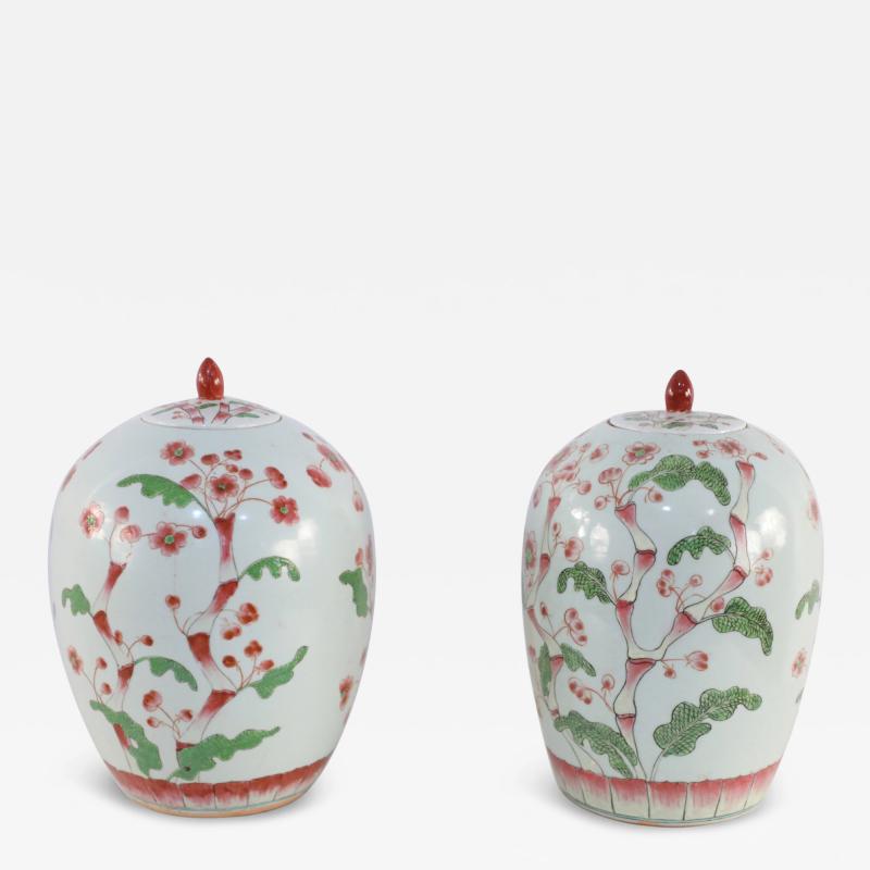 Pair of Chinese White and Pink Cherry Blossom Motif Lidded Porcelain Urns