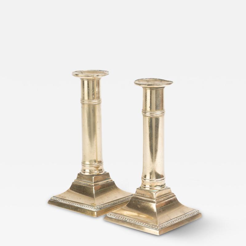 Pair of English cast brass columnar candle sticks on a square base 1810