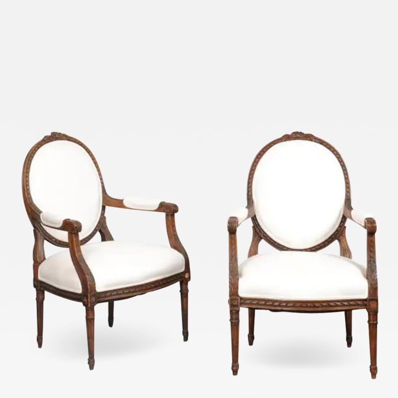 Pair of French 1850s Louis XVI Style Walnut Oval Back Upholstered Armchairs