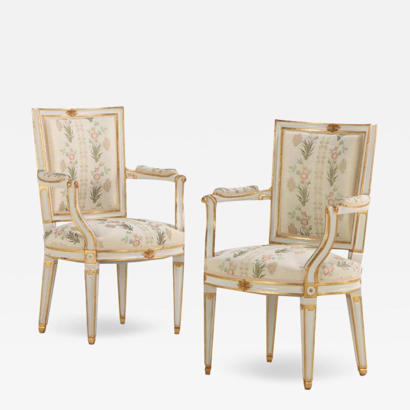 Pair of French Louis XIV style painted and gilt open arm chairs C 1990 