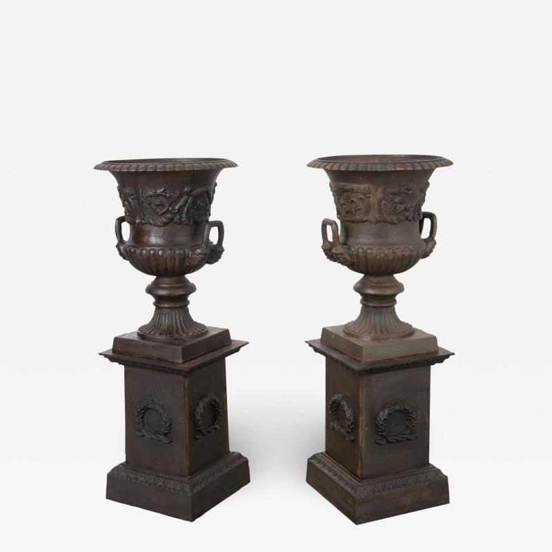 Pair of French Metal Urns on Pedestals