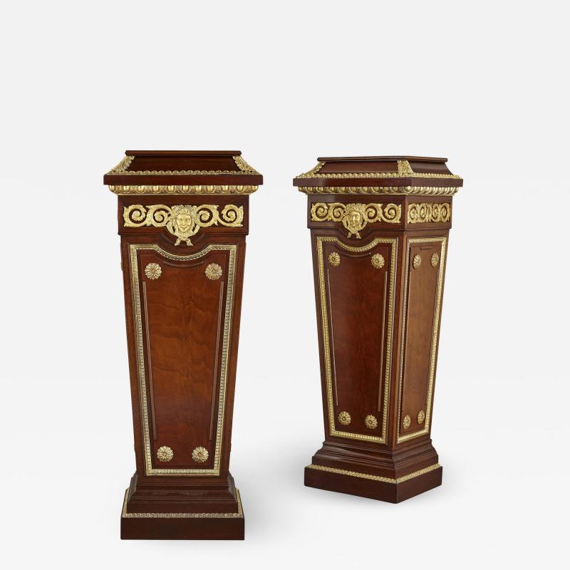 Pair of French Neoclassical style parcel gilt mahogany pedestals