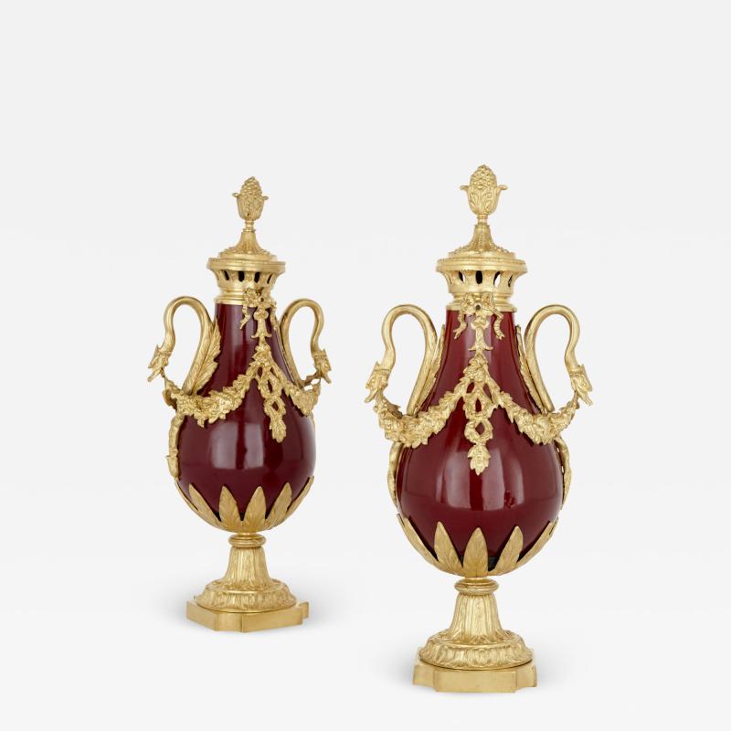 Pair of French Neoclassical style red t le and gilt bronze vases