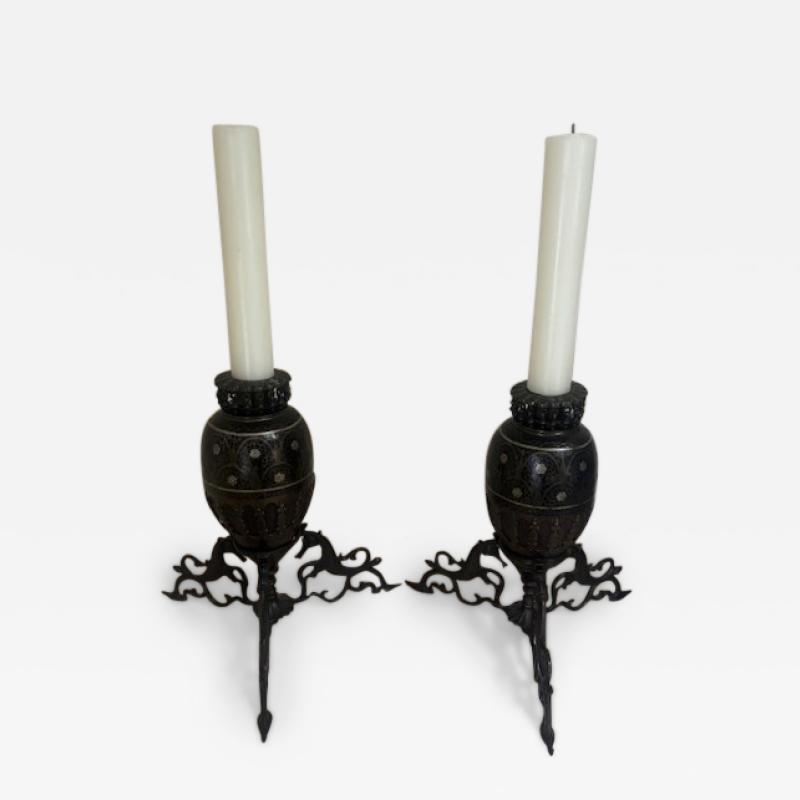 Pair of Middle Eastern candlesticks with brass inlay and 3 horse base